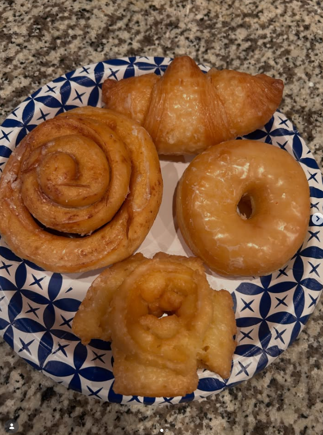 Cinnamon roll, croissant, glazed donut and apple fritter on a plate